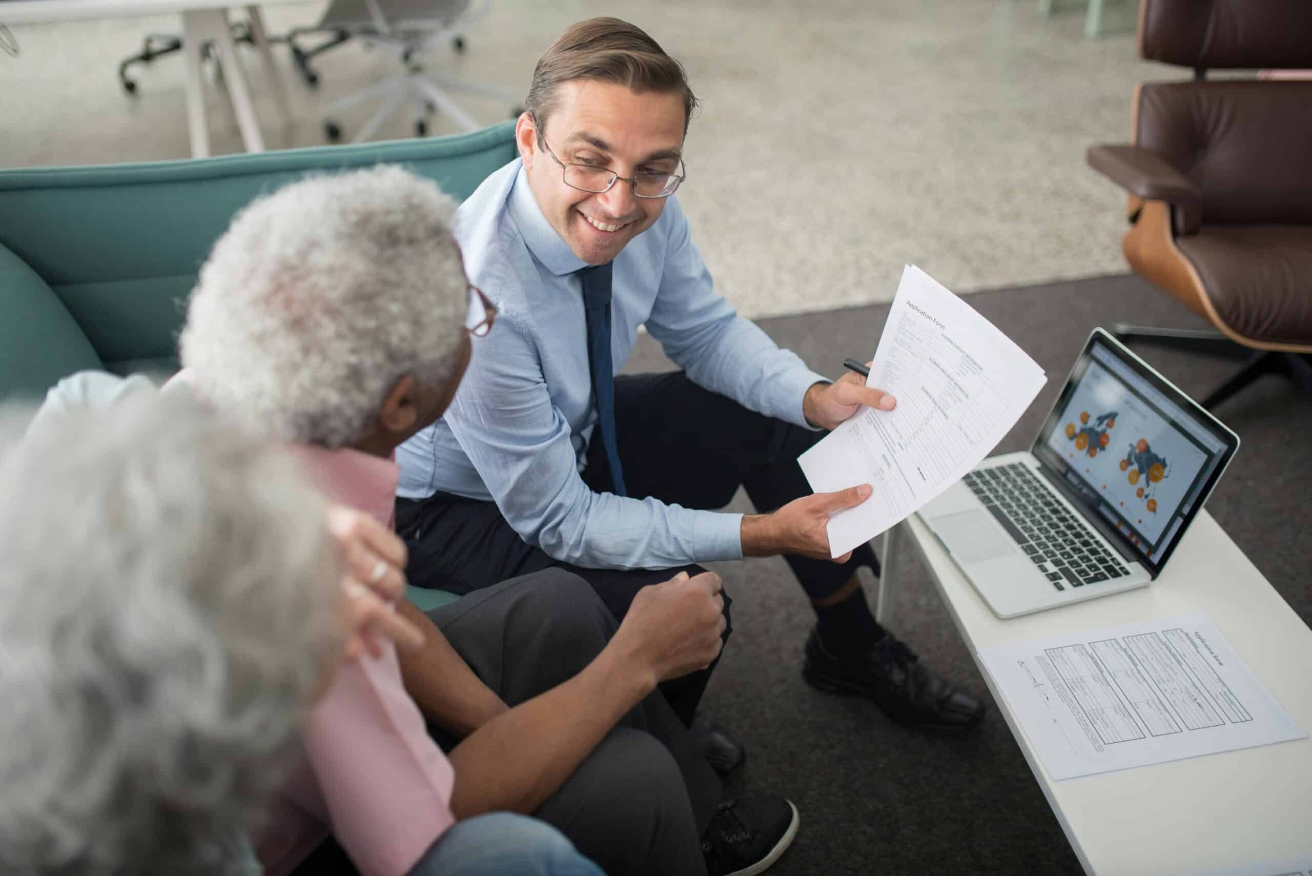 Businessman discussing documents with elderly couple