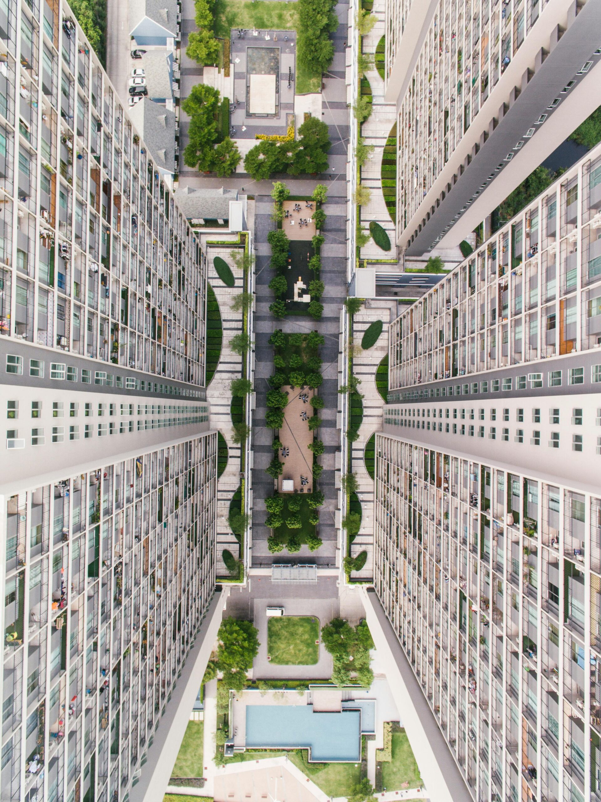 Aerial view of symmetric high-rise buildings with garden