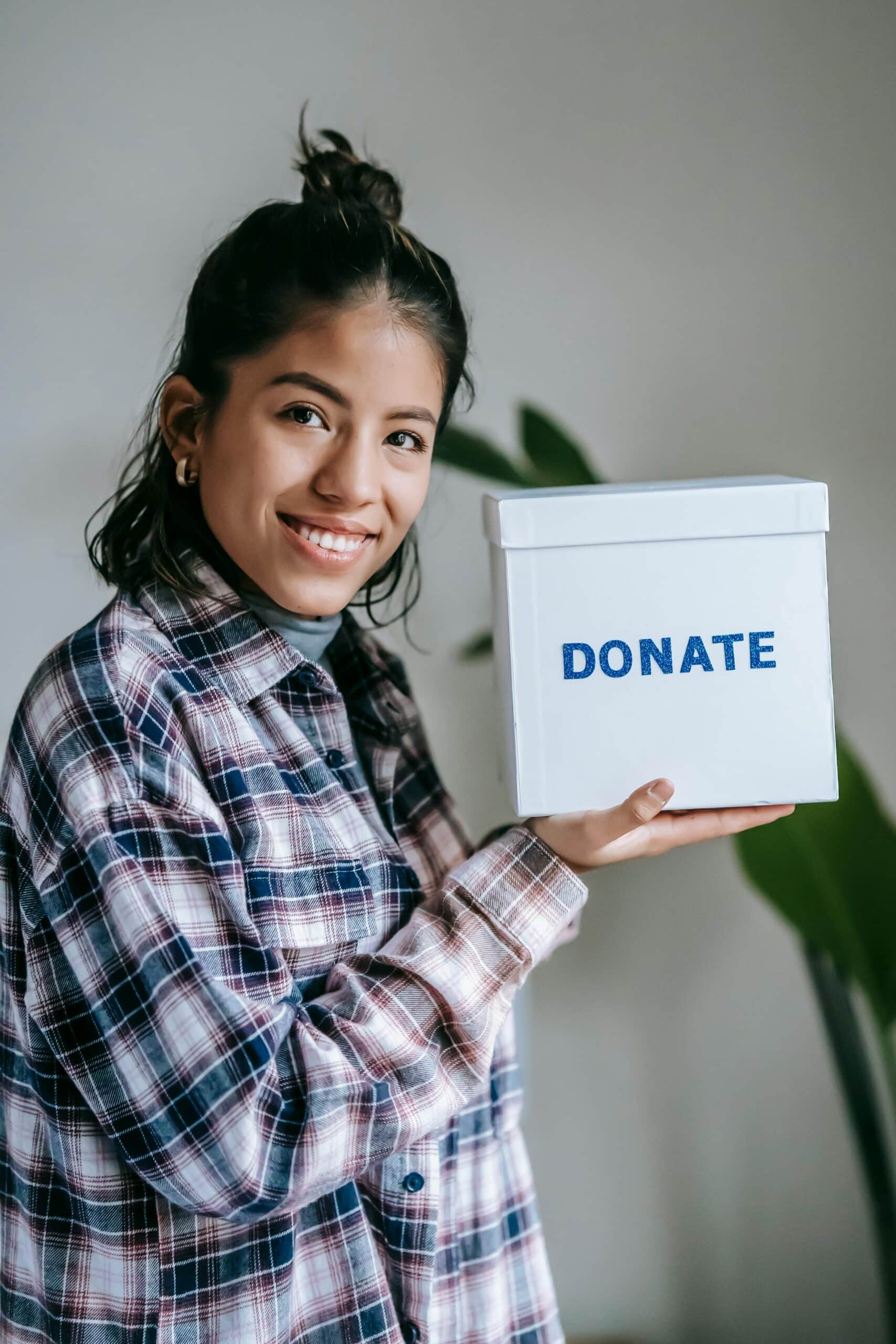 Woman holding donate box, smiling