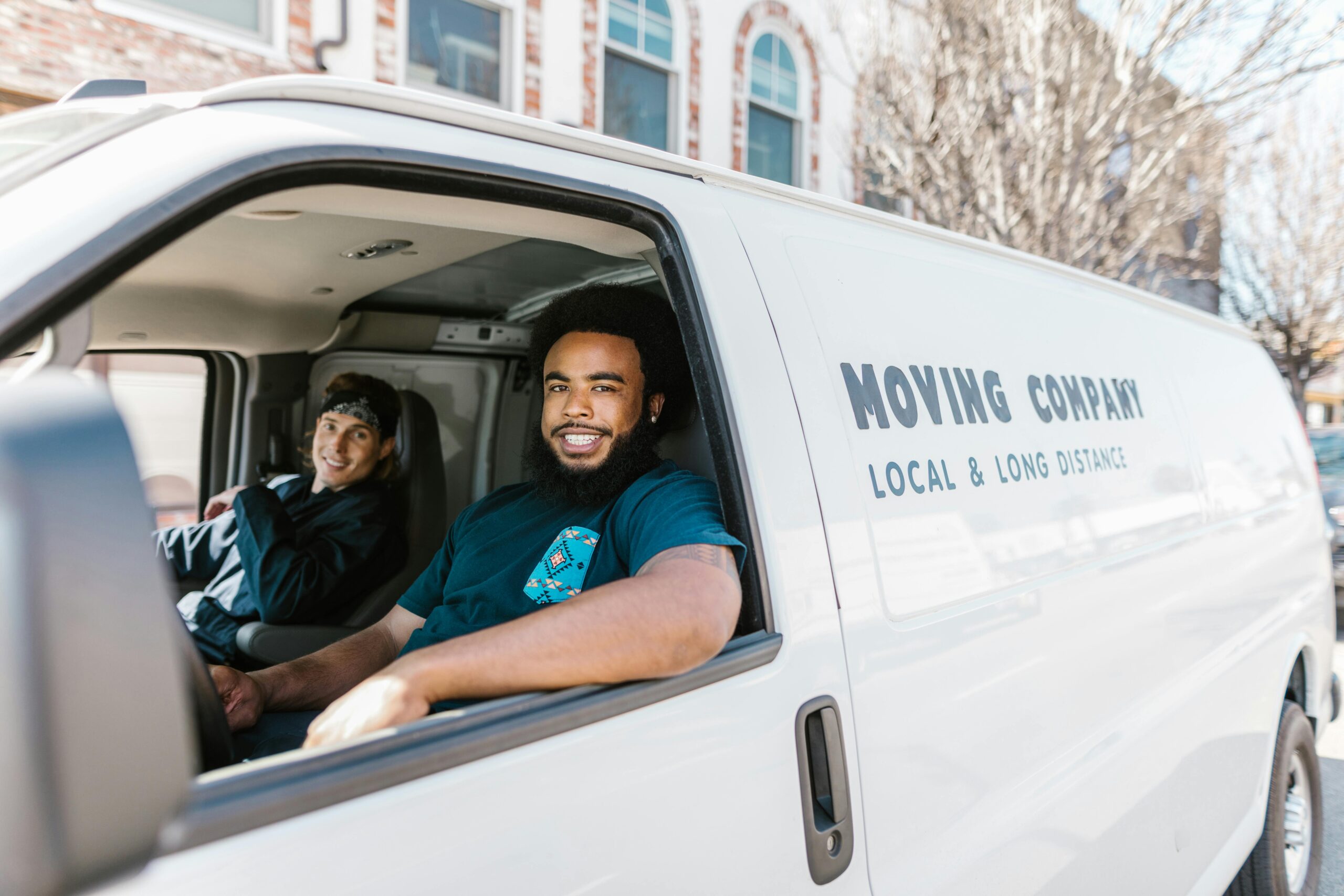 Movers smiling inside moving van