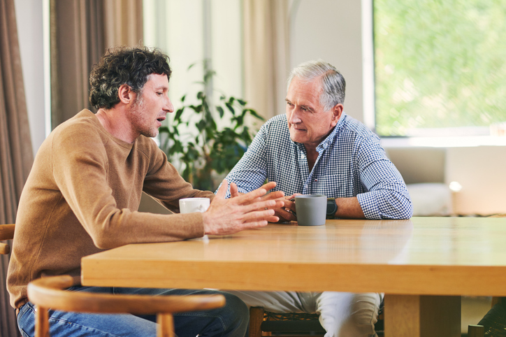Father and Son conversing over coffee at home
