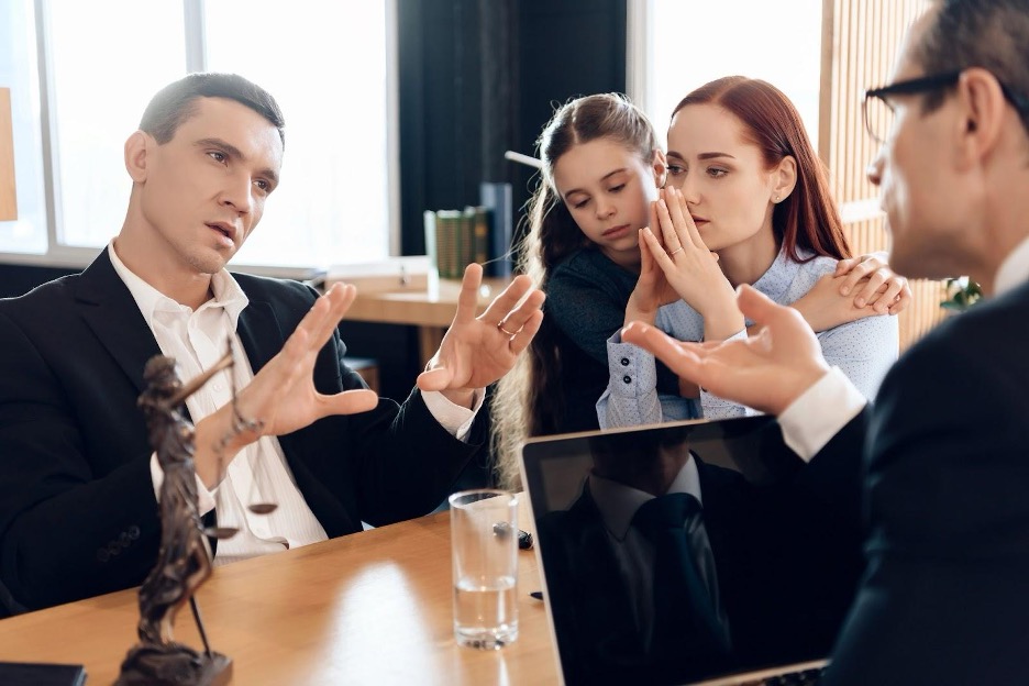 Family discussing issues with lawyer in office