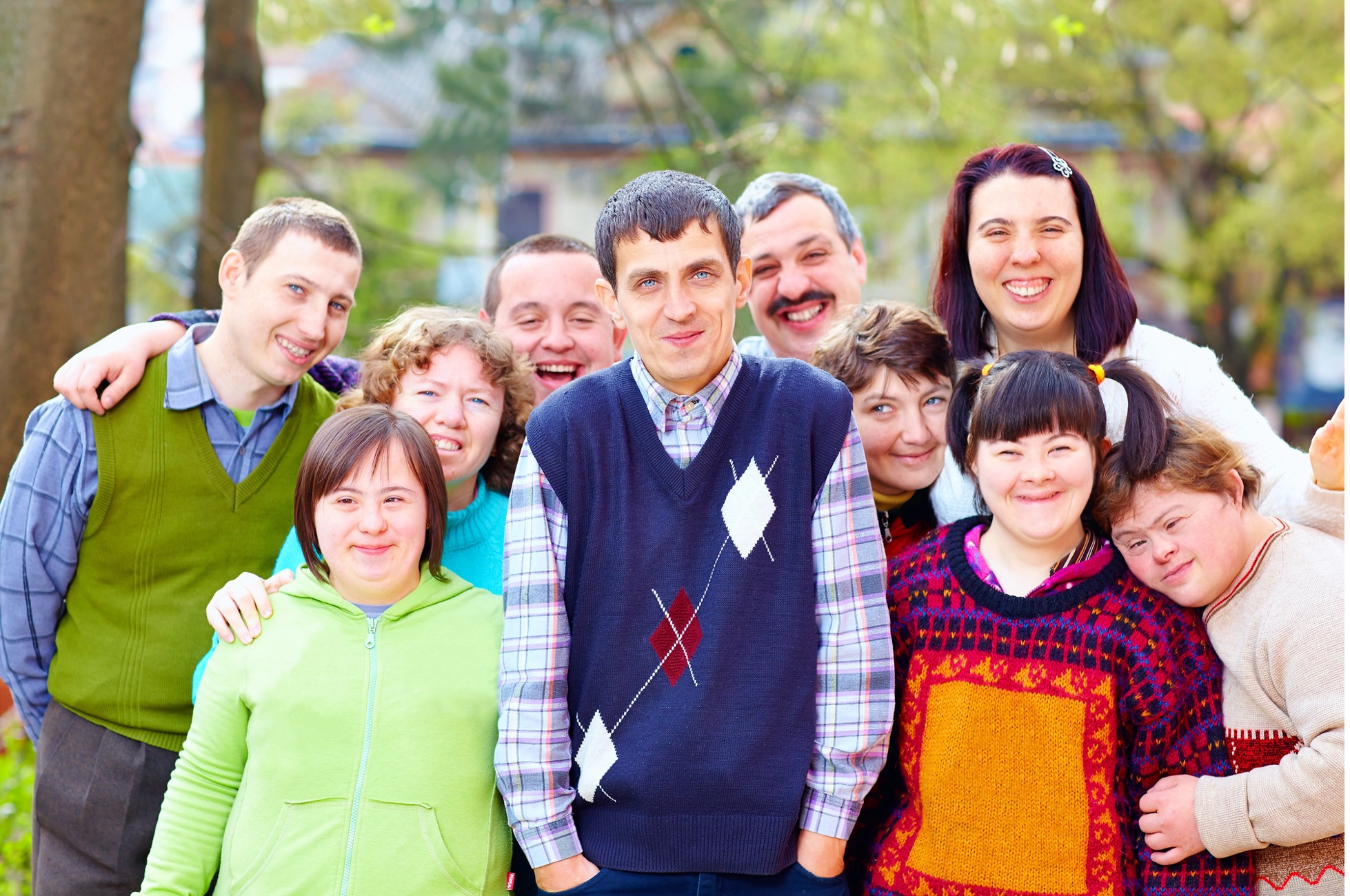 Diverse group of joyful friends embracing outdoors