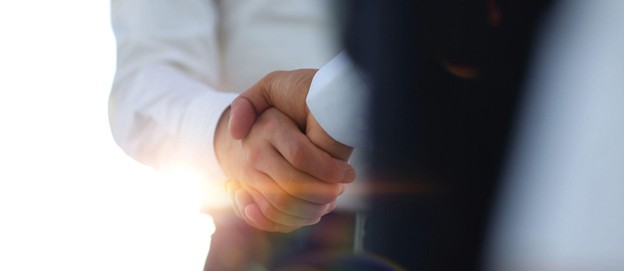Two individuals shaking hands after agreeing to establish a dynasty trust
