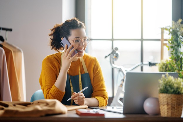 Female entrepreneur on phone in fashion studio